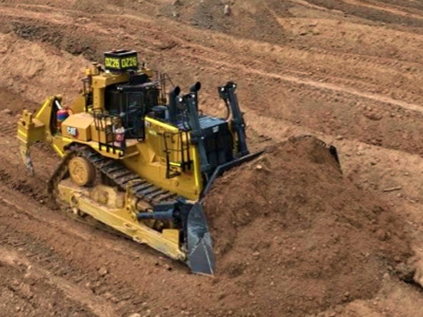 Dozer shaping a rehabilitated landform on red Pilbara earth
